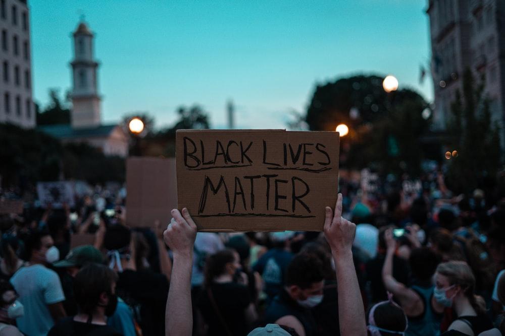 A Person Holding Up a 'Black Lives Matter' Placard During a Protest
